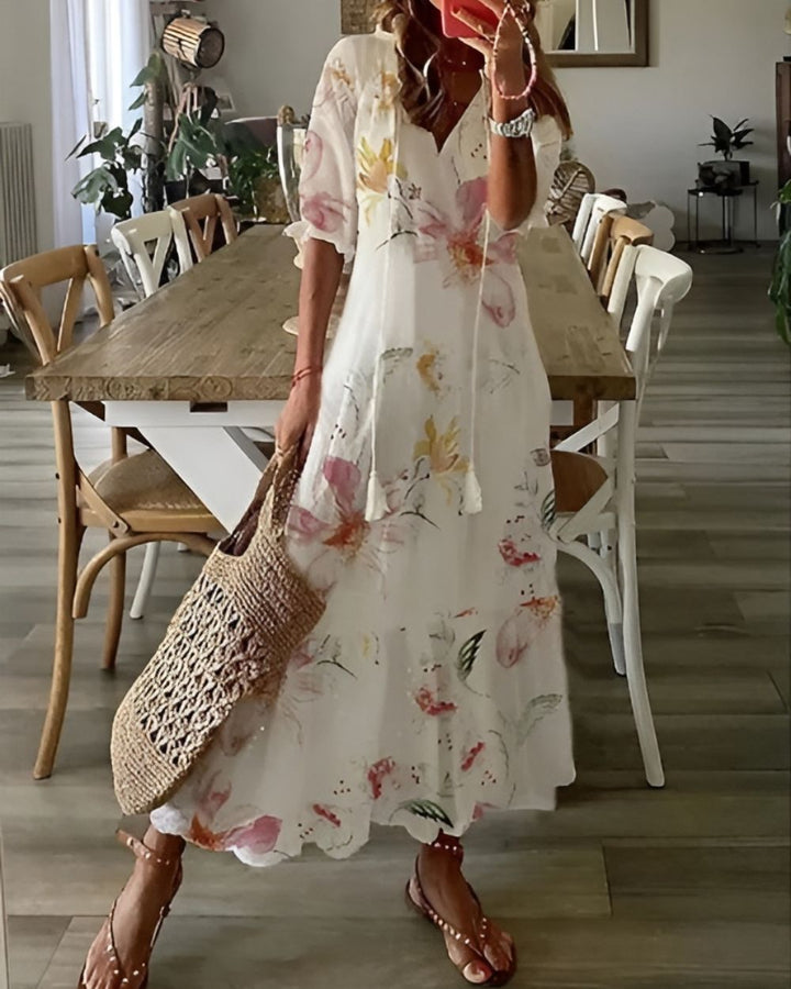 Boho covering dress in white with soft floral print and short sleeves.