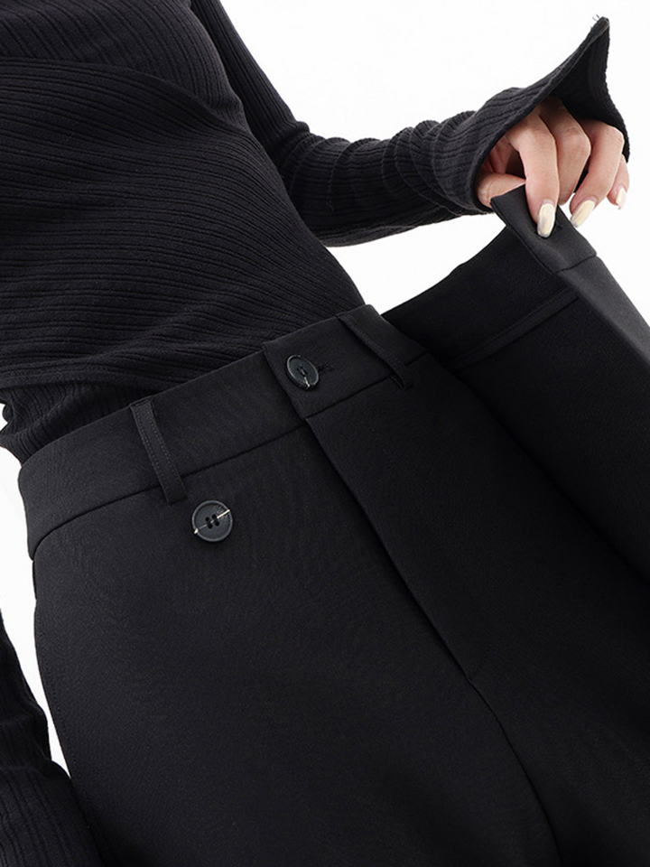 Black baggy trousers with belt loops, front pleats, and button closure