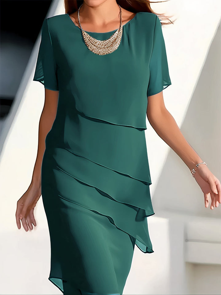 Green silk chiffon pleated dress with short sleeves and layered ruffle front