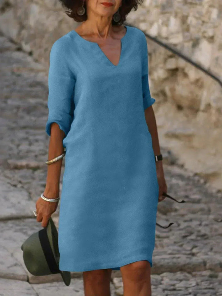 Sky blue V-neck dress with elbow-length sleeves and a straight, knee-length fit