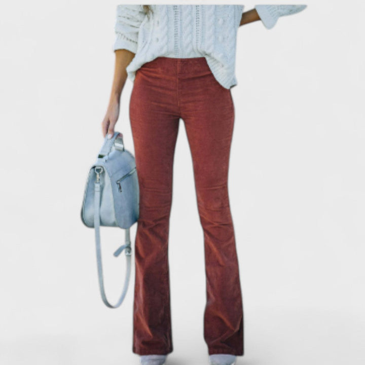Flared corduroy trousers, rust red with vertical cord texture and bootcut hem