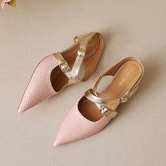 Pink textured leather slip-on mule with gold buckled straps and pointed toe.