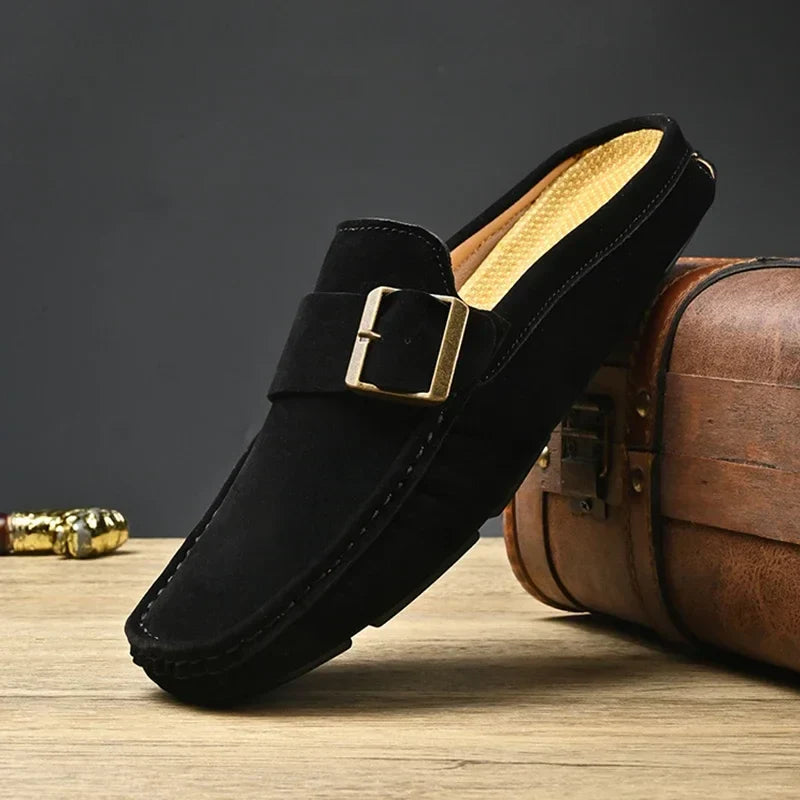 Black suede mules with square metal buckle strap and cushioned sole, slip-on