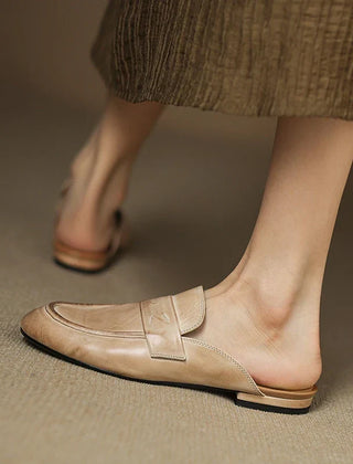 Beige leather mule with square toe slip-on design and strap across the top