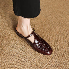 Brown leather mule on foot showing braided vamp detail and rounded toe