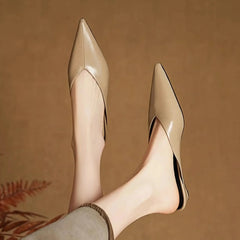 Beige leather mule heels, pointed toe and slim low heel profile