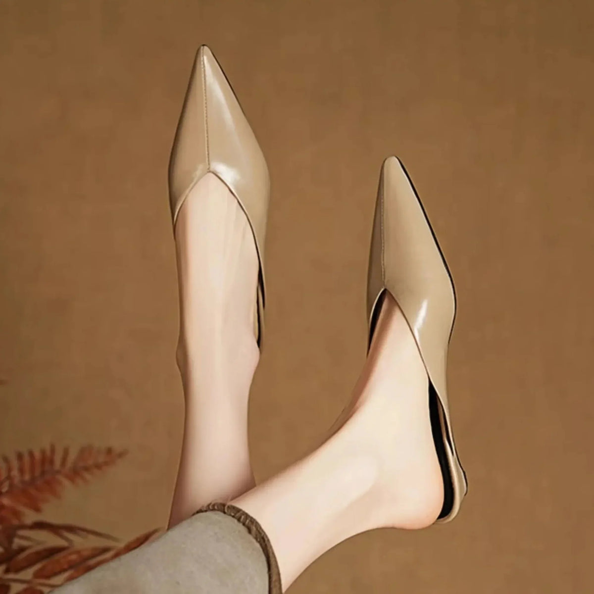 Beige leather mule heels, pointed toe and slim low heel profile