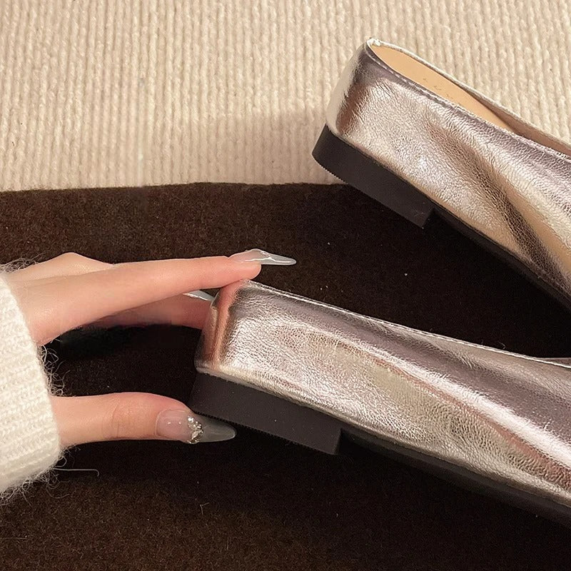 Lyra mules silver metallic heel view with low block heel and open back