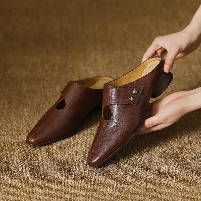 Brown leather mules pair with side cutouts and stud accent, low heel
