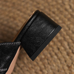Black leather mule outsole and low block heel with textured finish