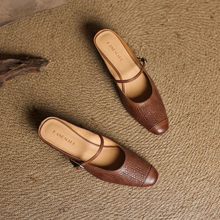 Two brown leather mules with square toe, buckle strap, and block heel