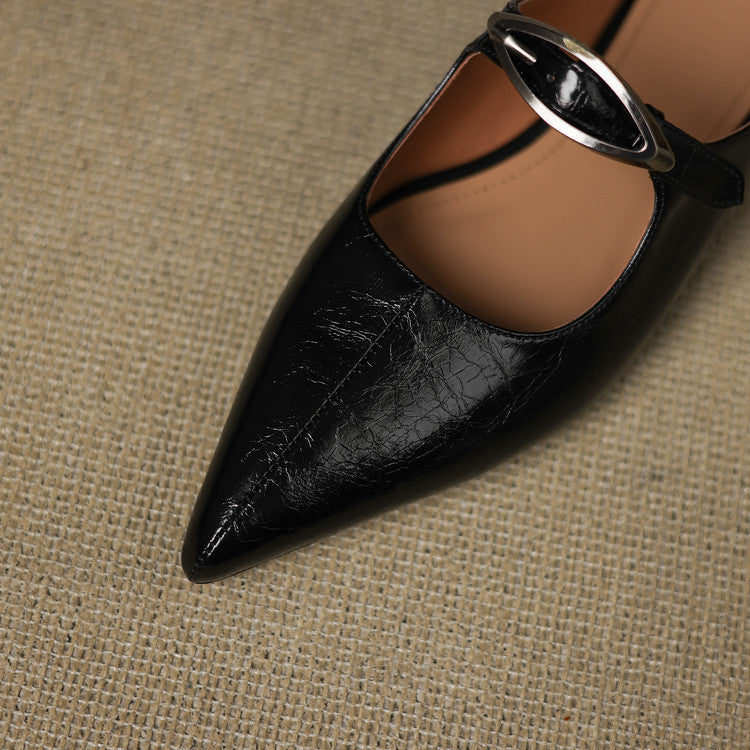 Close-up of black leather mule with pointed toe and silver buckle slingback strap