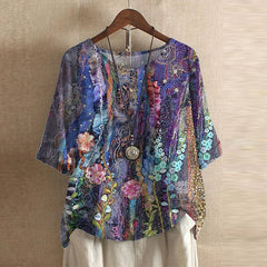 Women’s colorful floral blouse, deep purple with layered floral and ornament pattern, short sleeves.