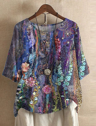 Women’s colorful floral blouse, deep purple with layered floral and ornament pattern, short sleeves.