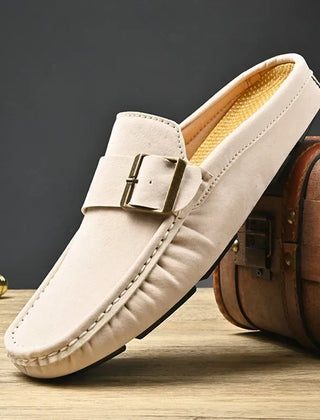 Cream suede mules with square buckle strap and stitched moc toe