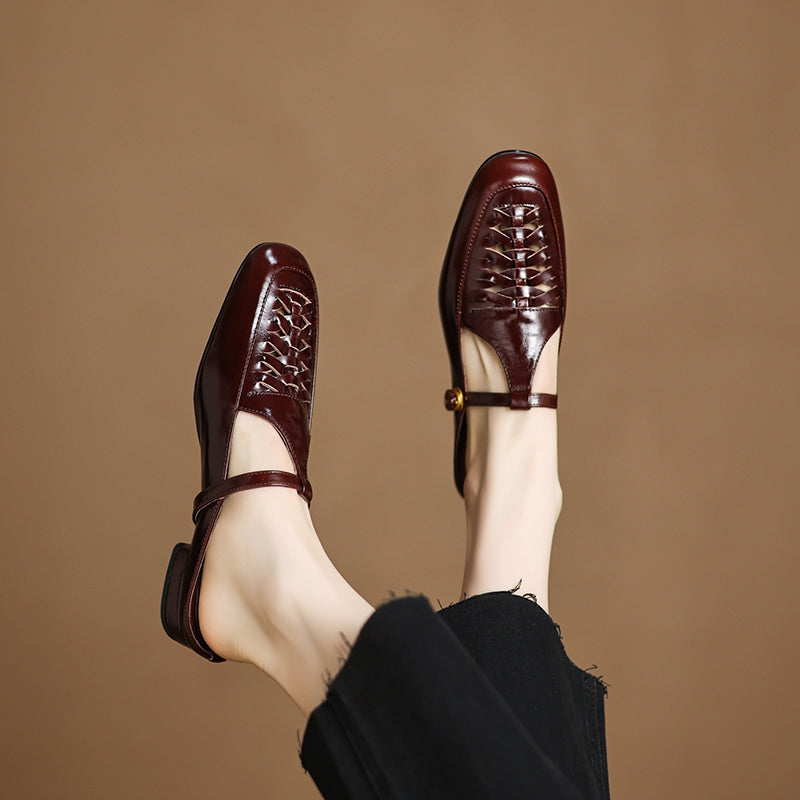 Pair of brown leather mules with braided uppers and strap with gold buckle