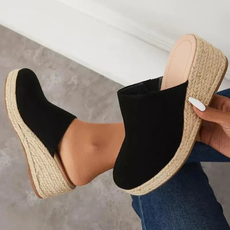 Black wedge slide sandals with jute-textured sole and open heel