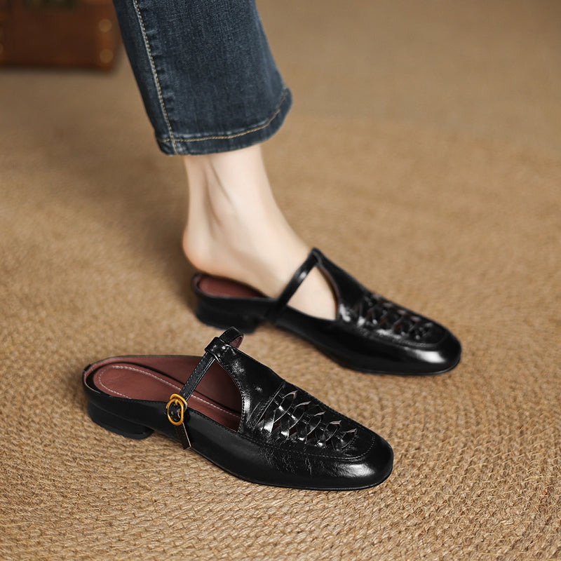 Black leather mule with braided vamp, sling strap, and round gold buckle