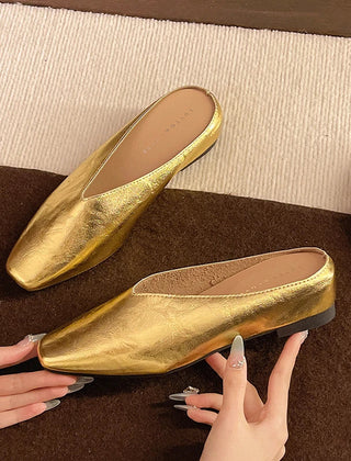 Gold metallic Lyra mules with pointed toe and low block heel, slip-on style