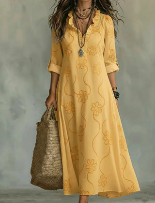 Yellow maxi dress with short sleeves and subtle floral pattern, V-neck.