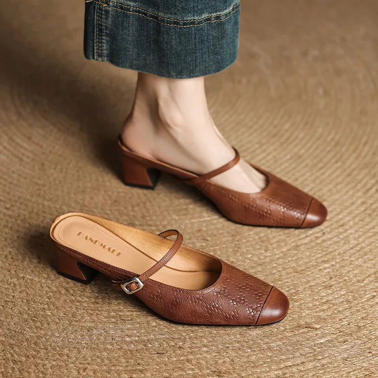 Brown leather mules with ankle strap and low block heel, shown as pair