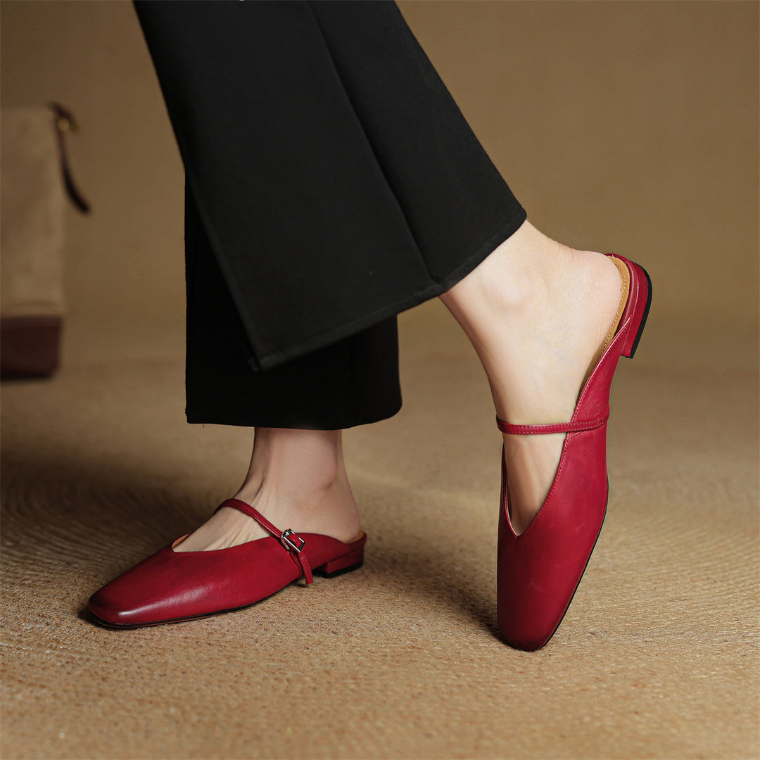 Maroon leather mule shoes with slingback strap and buckle; worn with dark pants