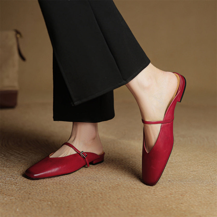 Maroon leather mule shoes with slingback strap and buckle; worn with dark pants