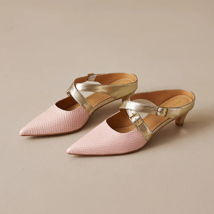 Pink textured leather mules with pointed toe, gold straps, and short block heels.