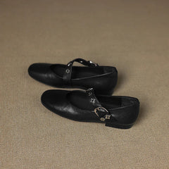 Black leather loafer flats with star accent strap and buckle