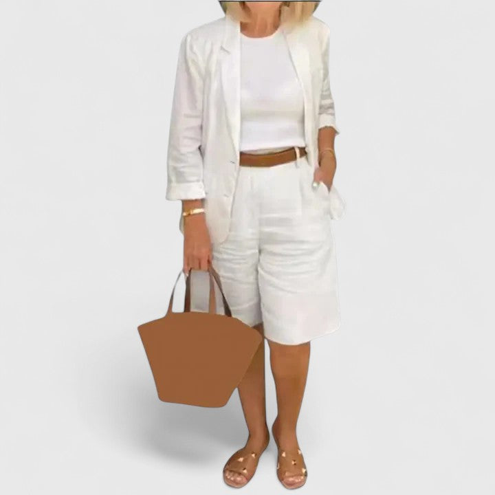 White 2-piece suit set with blazer jacket and shorts, with brown waist belt and tote
