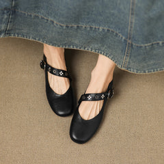 Black leather ballet flats with star-print strap and buckle detail