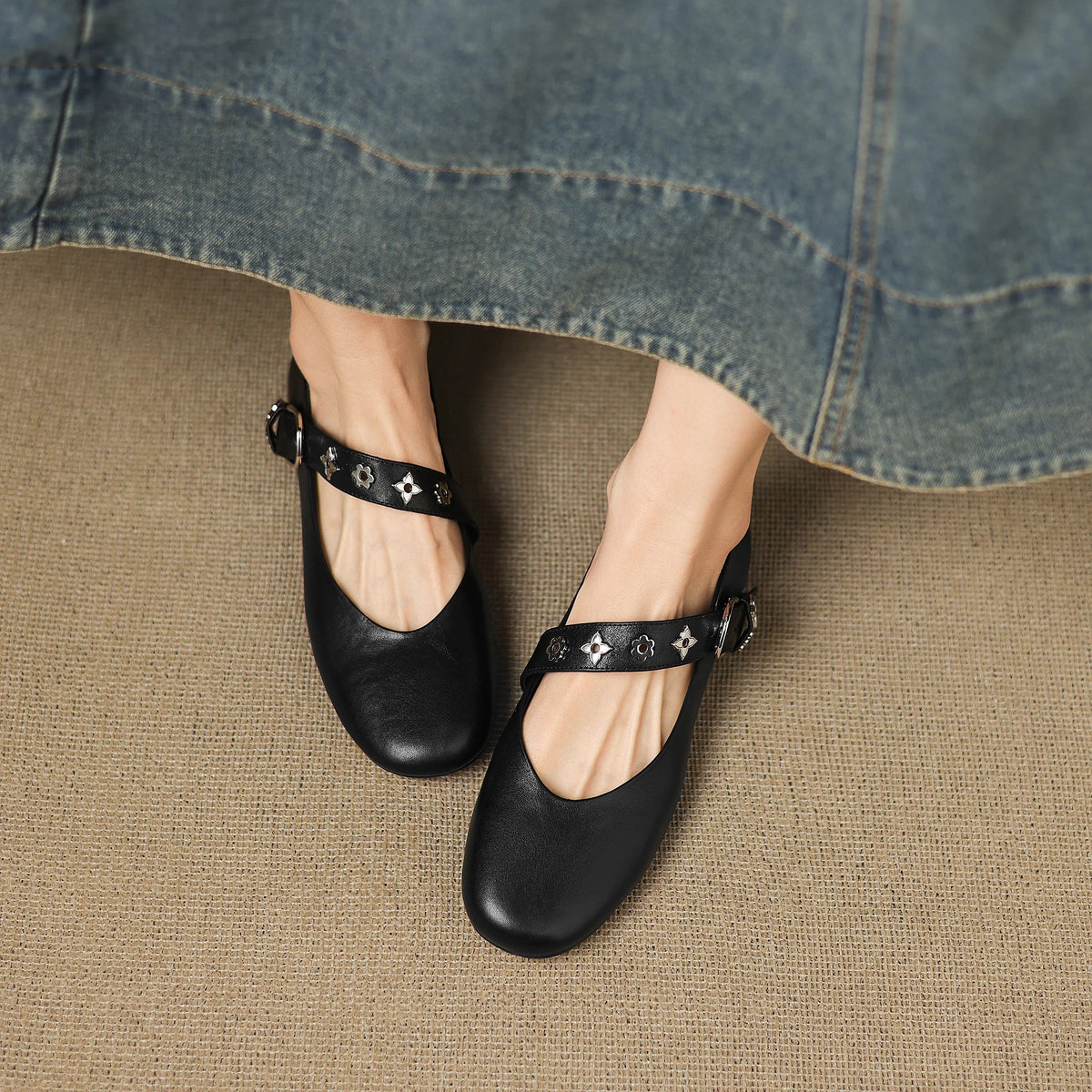 Black leather ballet flats with star-print strap and buckle detail