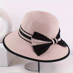 Pink wide brim sun hat with black ribbon band and bow