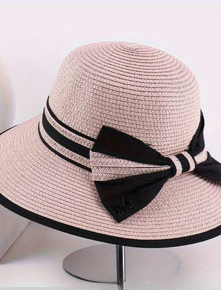 Pink wide brim sun hat with black ribbon band and bow