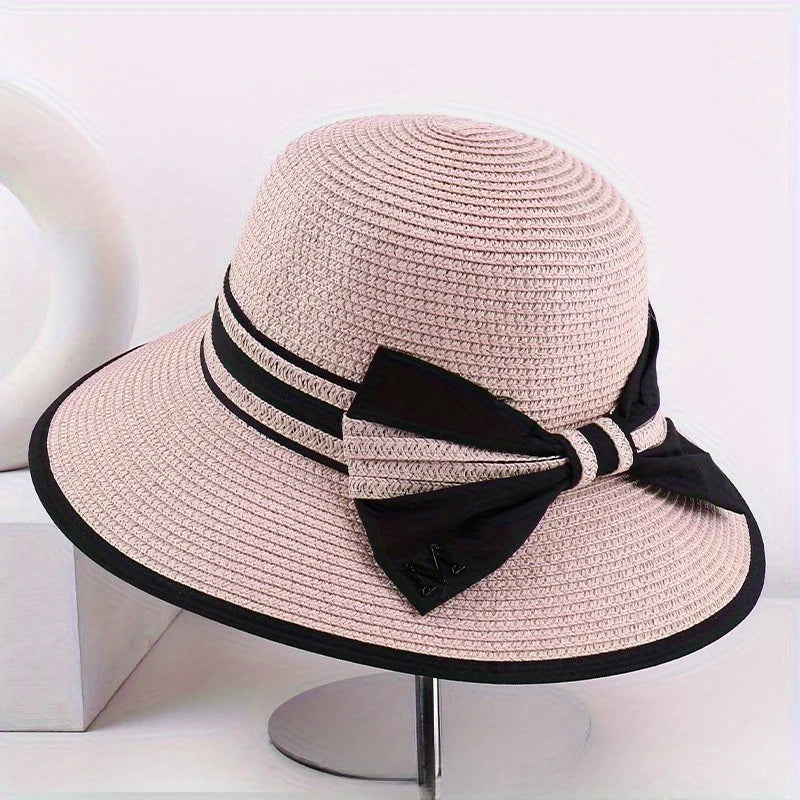 Pink wide brim sun hat with black ribbon band and bow