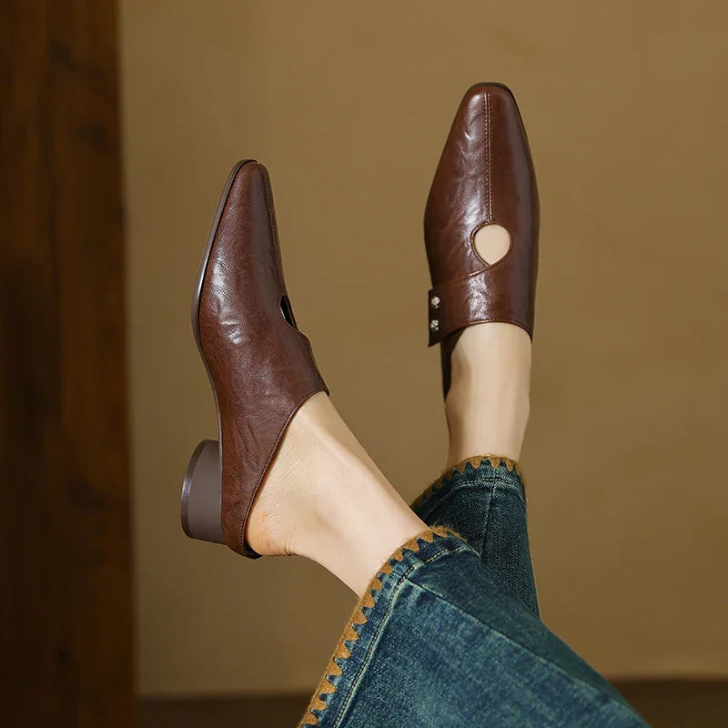 Brown leather mule with open side cutout and small stud detail, low block heel