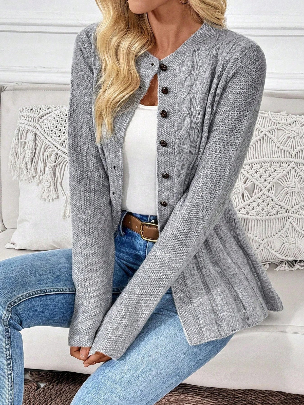 Gray ribbed cardigan with button placket and long sleeves, peplum-style hem
