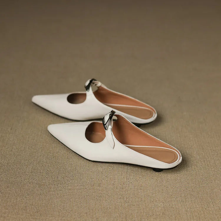 White leather mules with pointed toe and silver buckle slingback strap