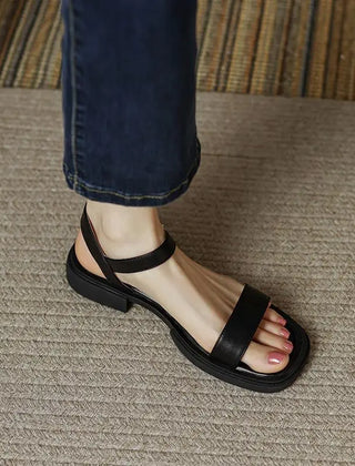 Black leather platform sandals with open toe and ankle strap