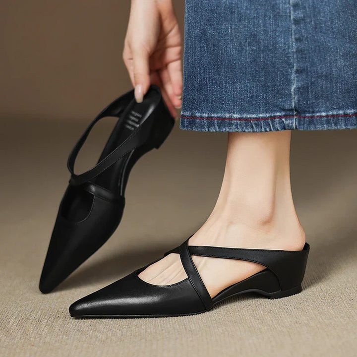 Black genuine leather mule with pointed toe, low block heel, and T-strap slingback