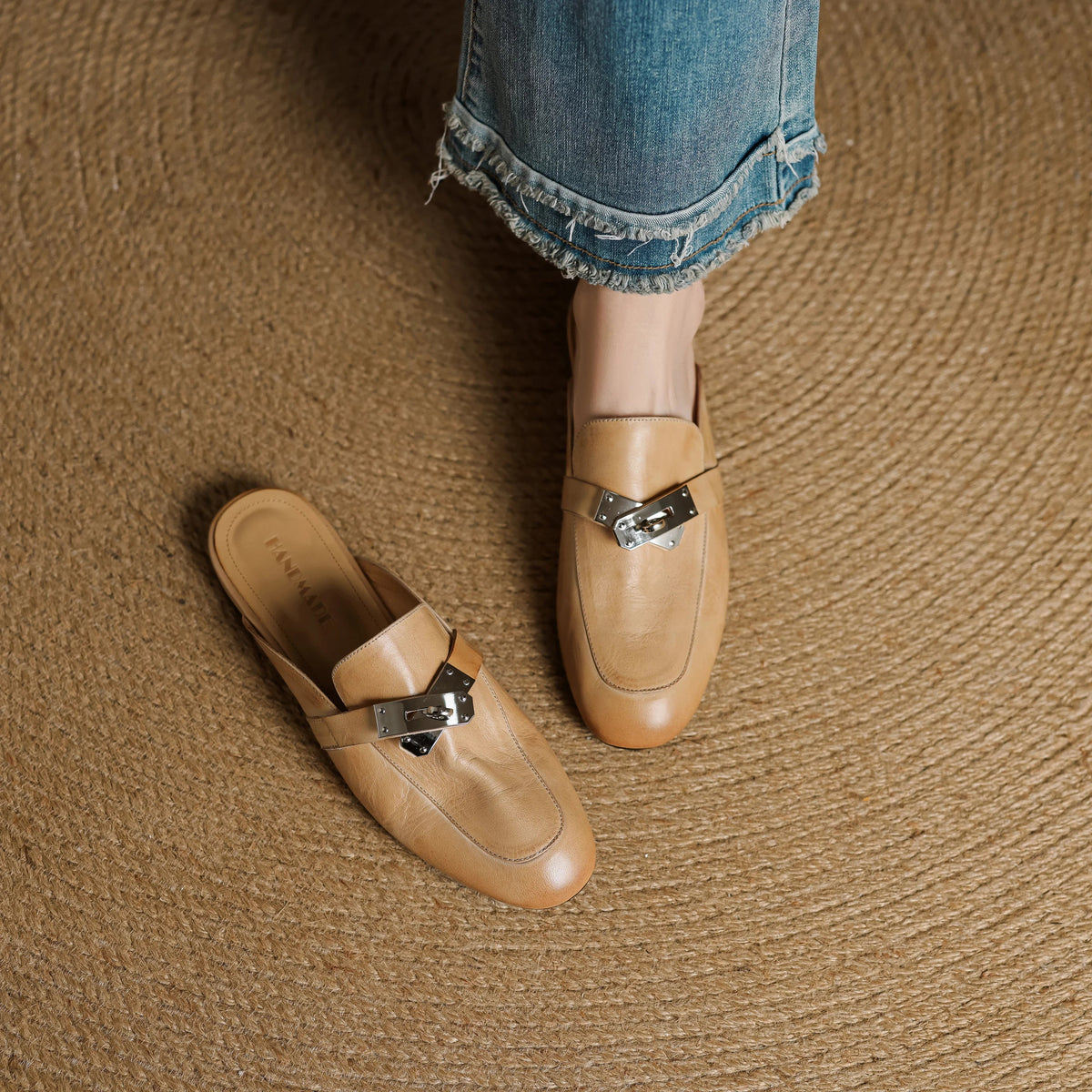 Pair of tan leather mules with square toe and silver buckle detail