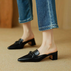 Black genuine leather mules with low block heel and slip-on loafer silhouette