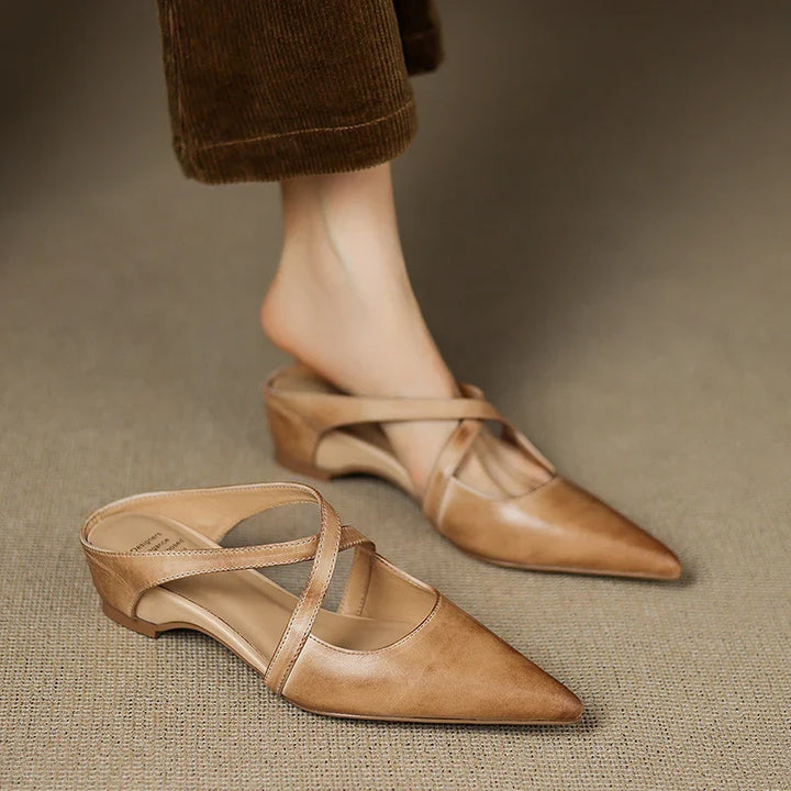 Tan leather mules pair, pointed toe with slingback straps and low block heel.