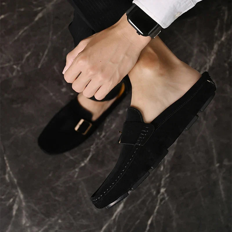 Black suede mule shoes with square buckle strap and stitched apron edge