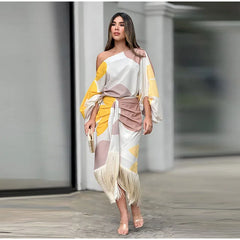 Model wearing abstract off-shoulder top and fringe-hem midi skirt in white and yellow