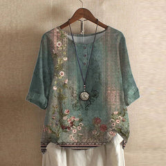 Women’s vintage floral blouse, green base with pink and beige flower print, short sleeves.