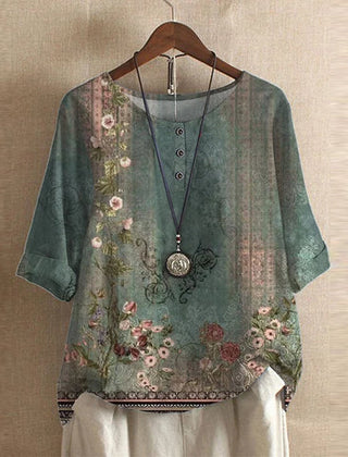 Women’s vintage floral blouse, green base with pink and beige flower print, short sleeves.