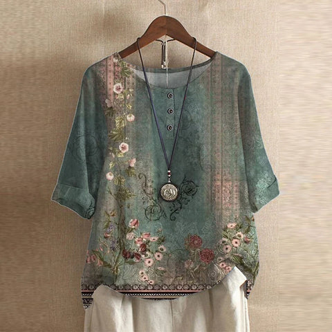 Women’s vintage floral blouse, green base with pink and beige flower print, short sleeves.