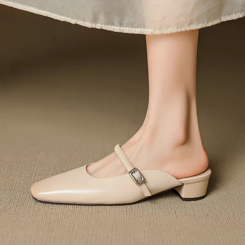 Beige Mary Jane mule with elastic strap, square buckle, and low block heel front view