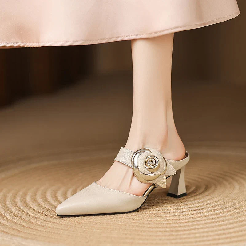 Beige genuine leather heels with pointed toe, ankle strap, and rosette buckle detail